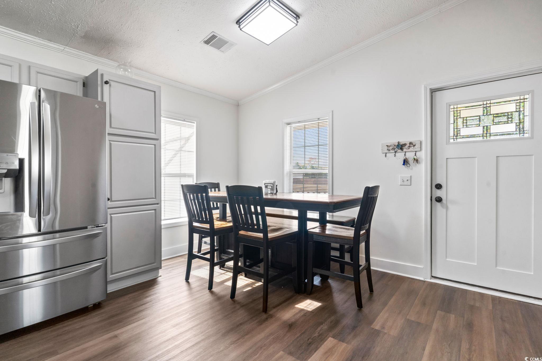 2977 Silverleaf Circle Loris, SC 29569 - Photo 3 of 36 Dining room featuring ornamental molding, a textured ceiling, dark wood finished floors, and lofted ceiling