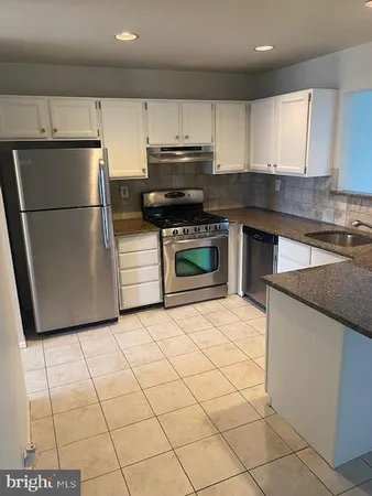 a kitchen with cabinets appliances and a counter top space