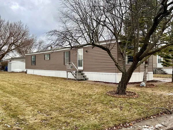 a white house that has a tree in front of it
