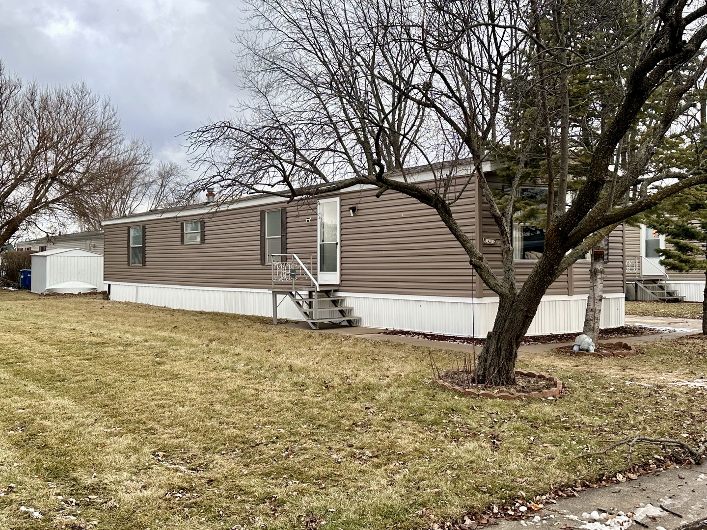1021 Springdale Lane DeKalb, IL 60115 - Photo 11 of 12 a white house that has a tree in front of it