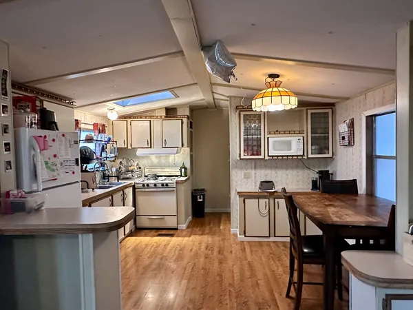 a kitchen with stove a refrigerator and dining table