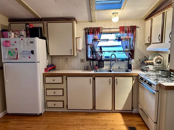 a kitchen with refrigerator and window
