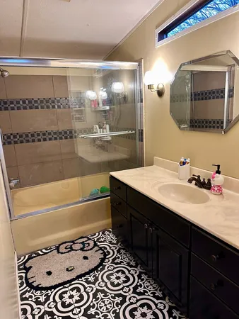 a bathroom with a bathtub sink and mirror
