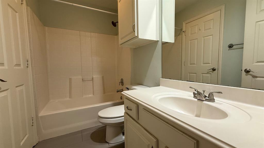 18240 Midway Road, Unit 1204 Dallas, TX 75287 - Photo 12 of 27 a bathroom with a sink a toilet and shower