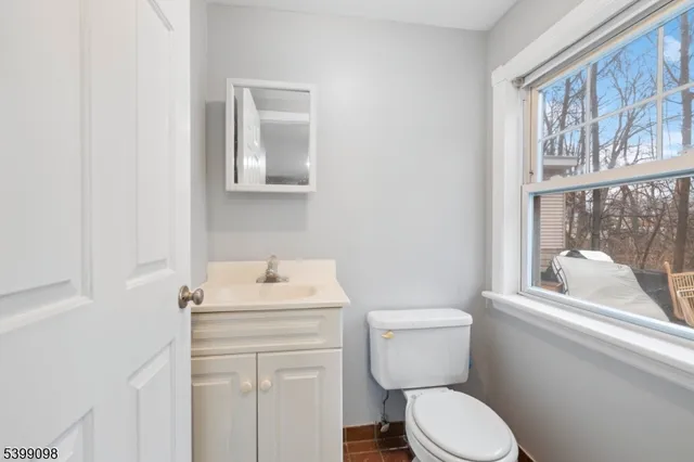 a bathroom with a sink a mirror and a vanity