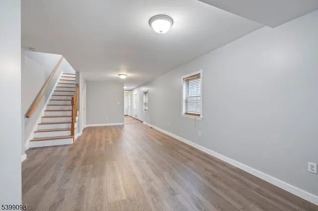 a kitchen with granite countertop white cabinets and stainless steel appliances
