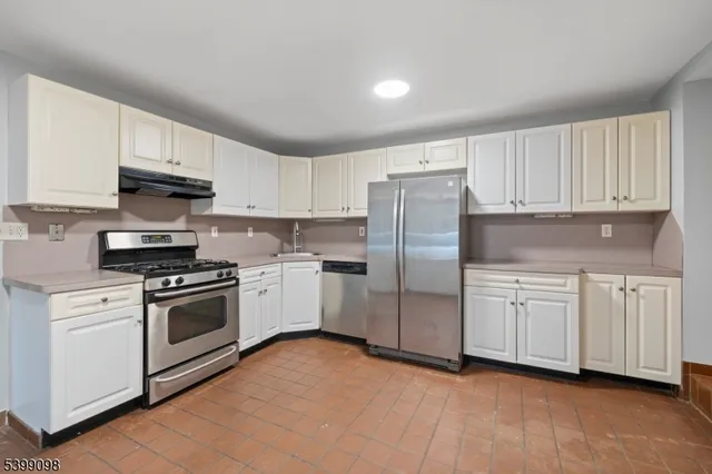 a kitchen with stainless steel appliances a refrigerator a stove a microwave and cabinets