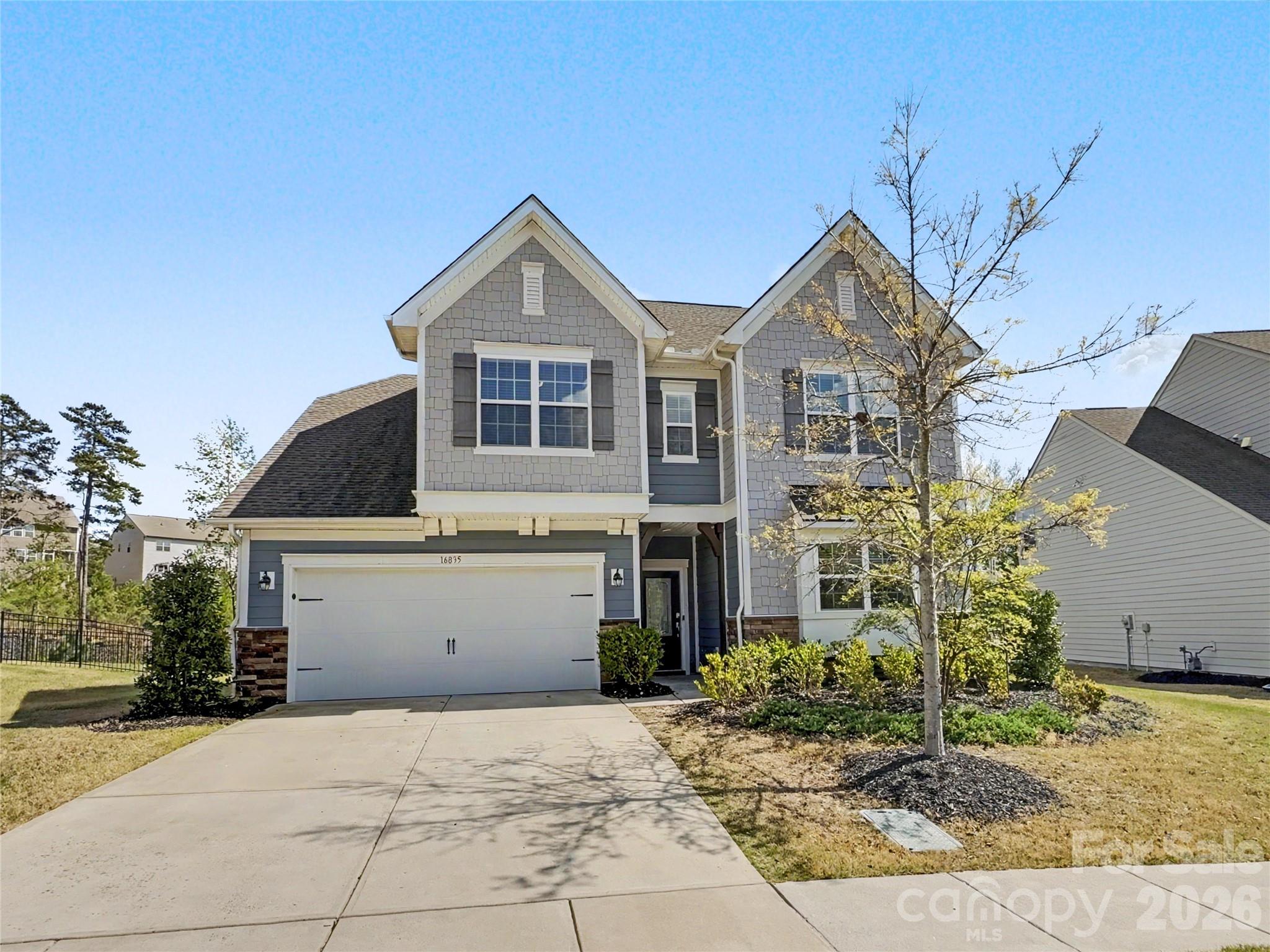 16835 Cozy Cove Road Charlotte, NC 28278 - Photo 1 of 32 a front view of a house with garden