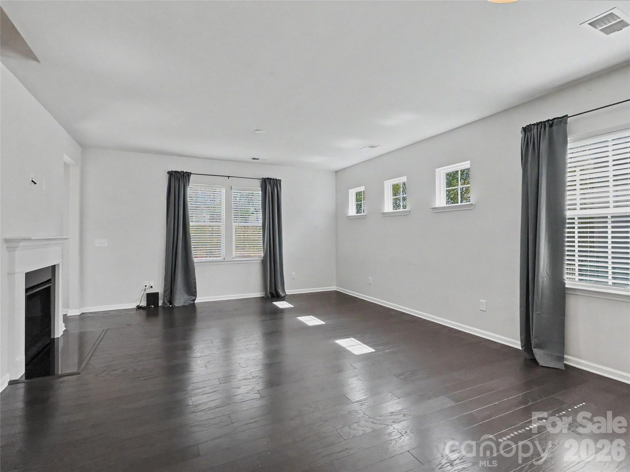 16835 Cozy Cove Road Charlotte, NC 28278 - Photo 11 of 32 a view of an empty room with wooden floor and a window
