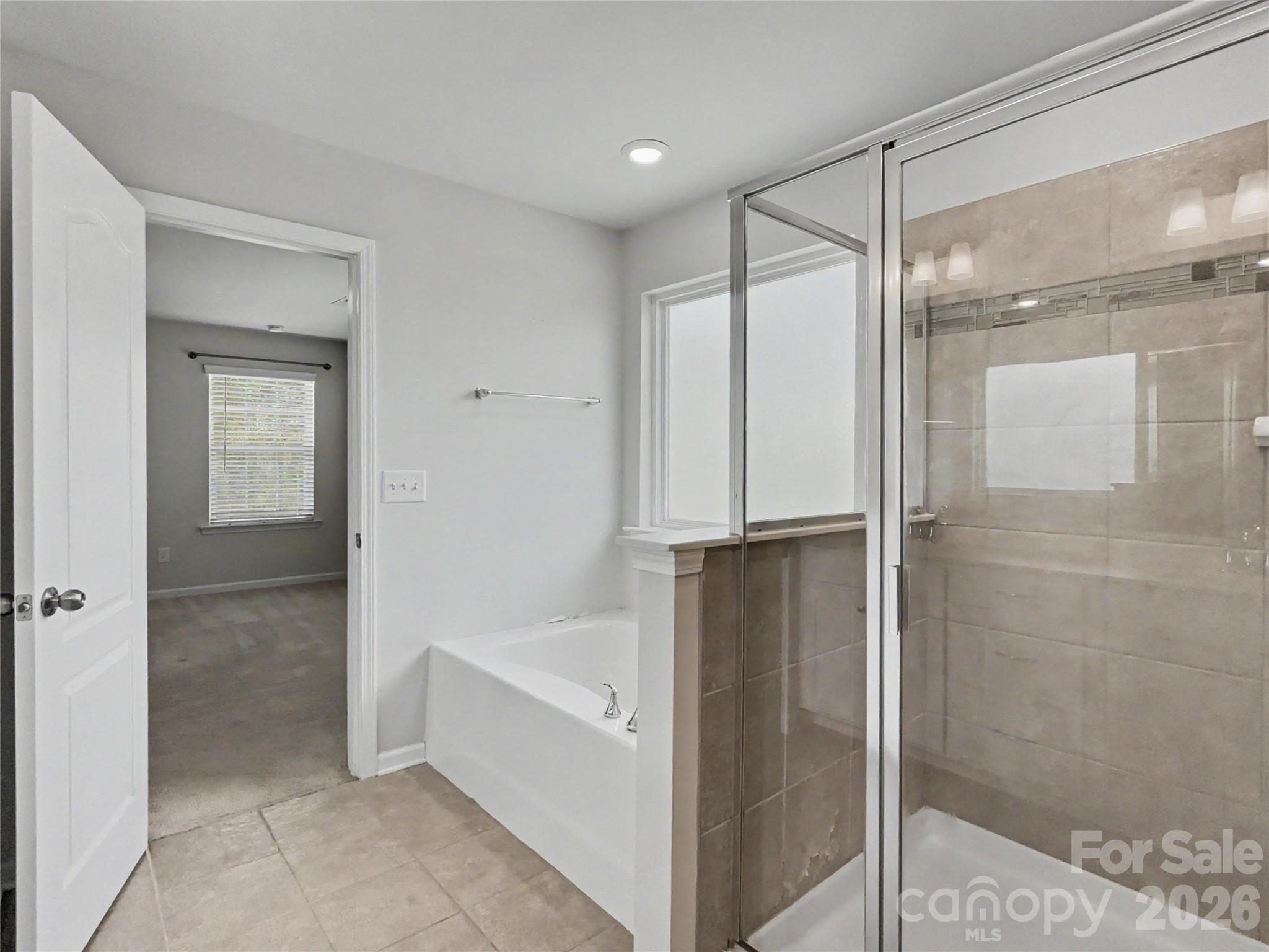 16835 Cozy Cove Road Charlotte, NC 28278 - Photo 19 of 32 a bathroom with a bathtub and a shower