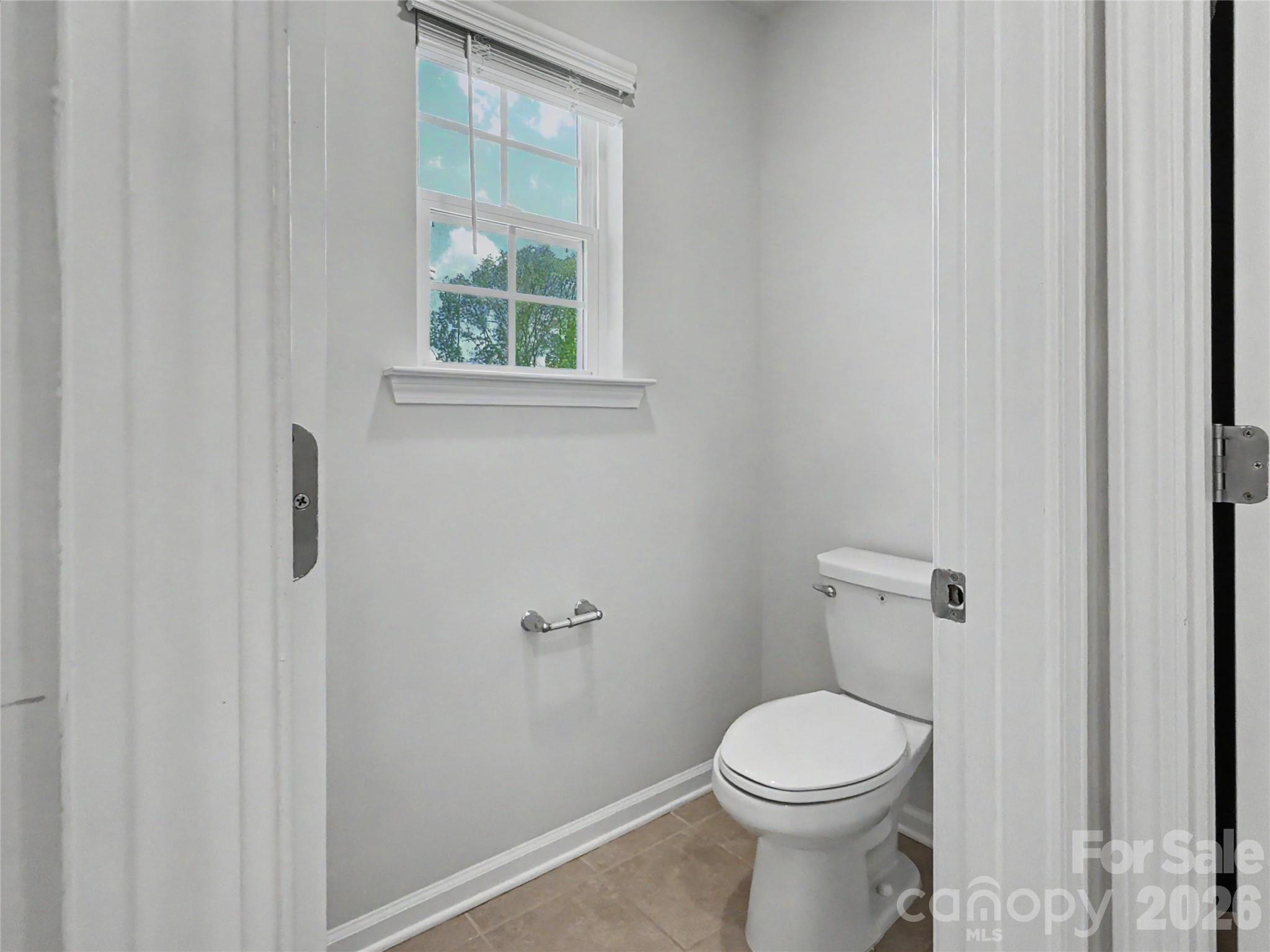 16835 Cozy Cove Road Charlotte, NC 28278 - Photo 20 of 32 a white toilet sitting next to a window