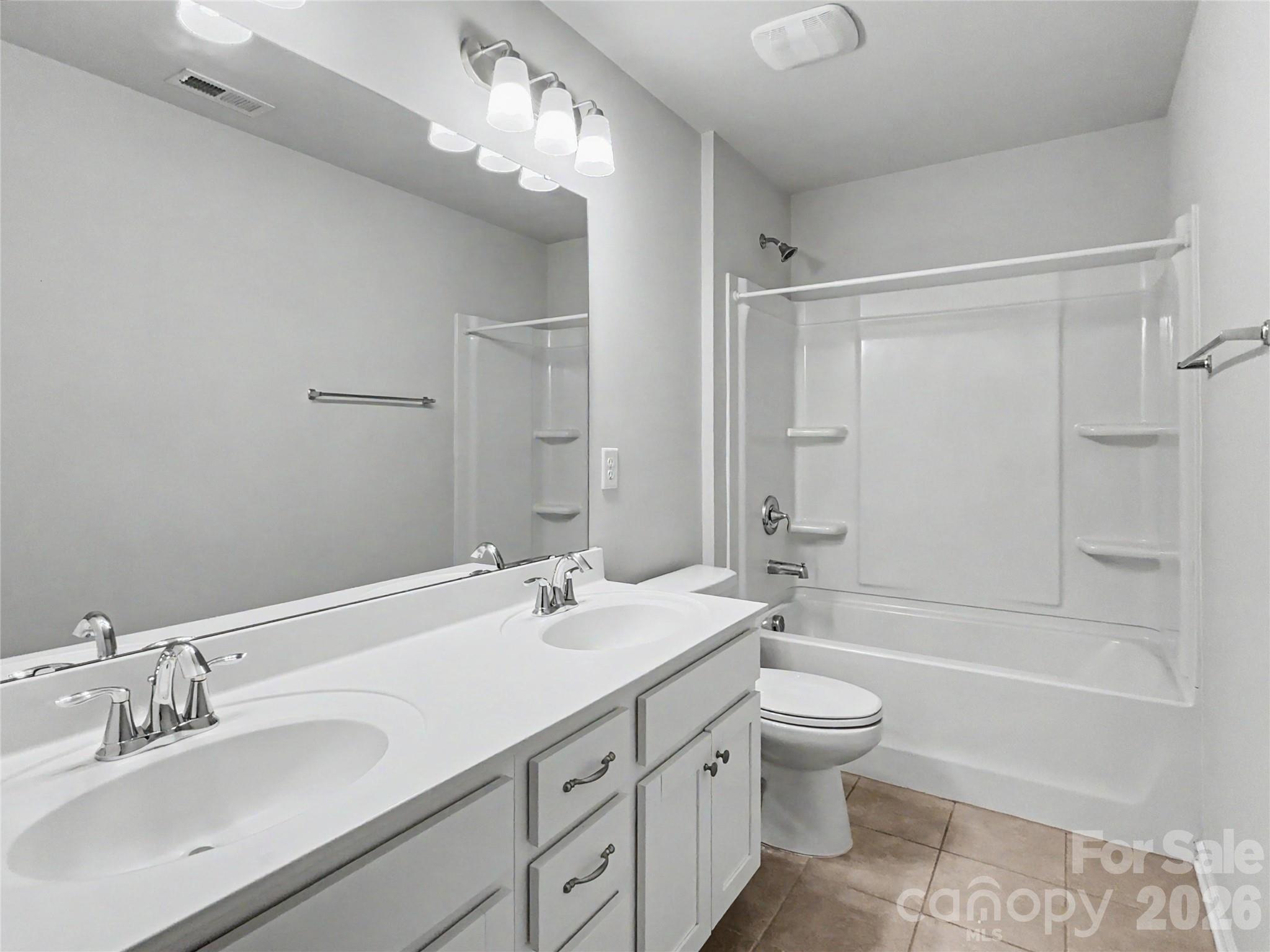 16835 Cozy Cove Road Charlotte, NC 28278 - Photo 24 of 32 a bathroom with a double vanity sink toilet mirror and shower