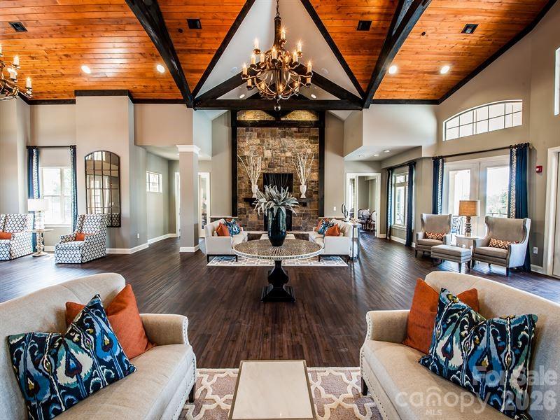 16835 Cozy Cove Road Charlotte, NC 28278 - Photo 32 of 32 a living room with furniture a fireplace and a chandelier