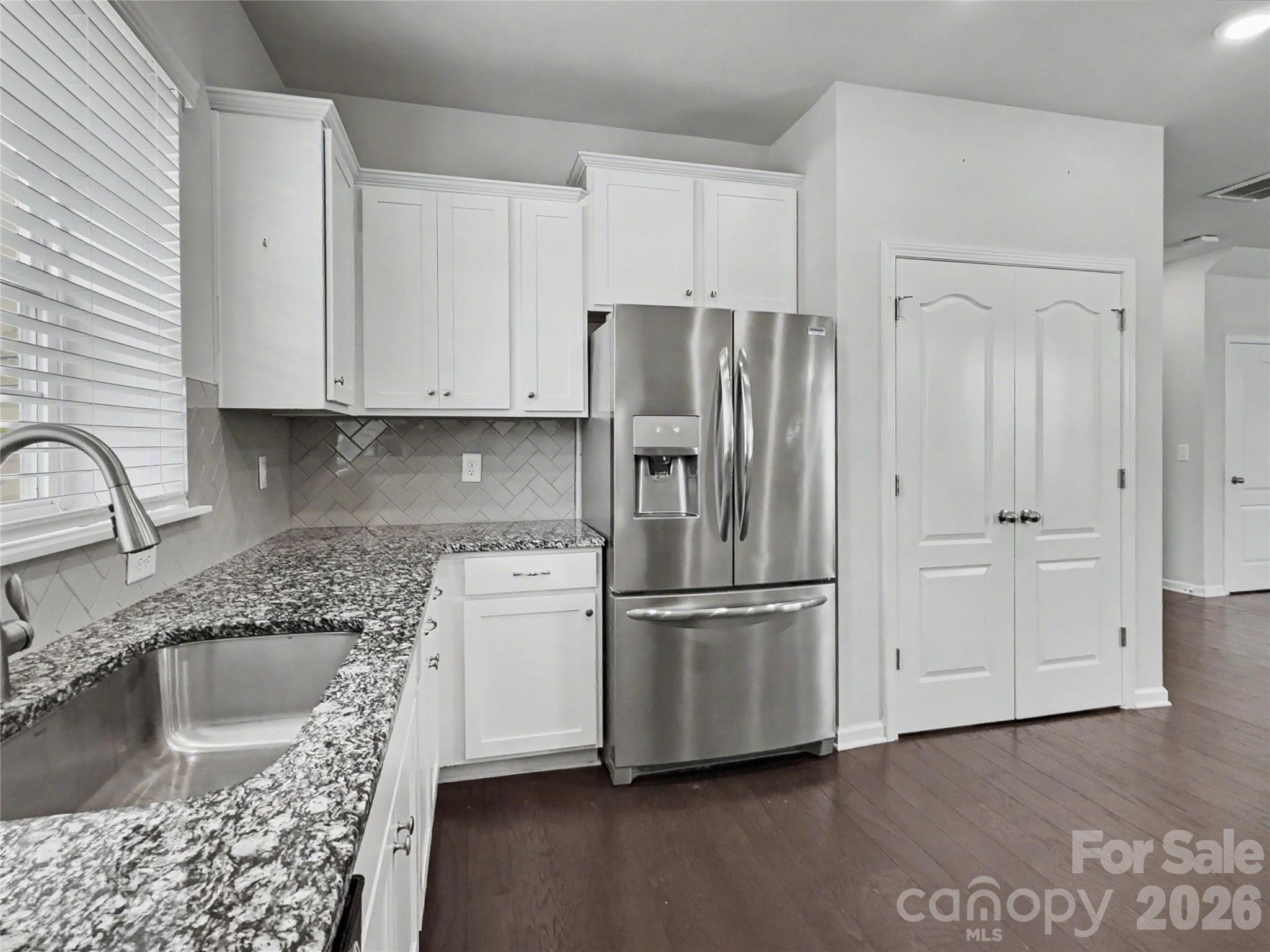 16835 Cozy Cove Road Charlotte, NC 28278 - Photo 7 of 32 a kitchen with stainless steel appliances granite countertop a refrigerator sink and cabinets