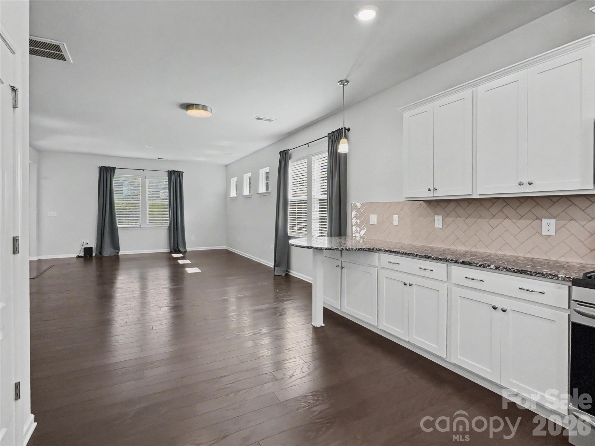 16835 Cozy Cove Road Charlotte, NC 28278 - Photo 9 of 32 a open kitchen with granite countertop white cabinets and wooden floor