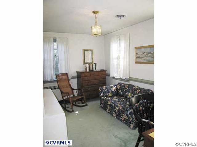 409 Henri Road Richmond, VA 23226 - Photo 8 of 10 a living room with furniture and a chandelier