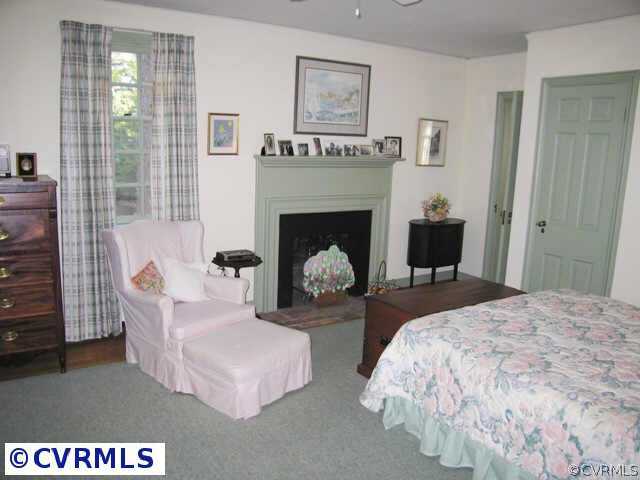 409 Henri Road Richmond, VA 23226 - Photo 9 of 10 a bed room with a bed and a fireplace