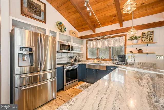 a living room with furniture a fireplace a flat screen tv and a window