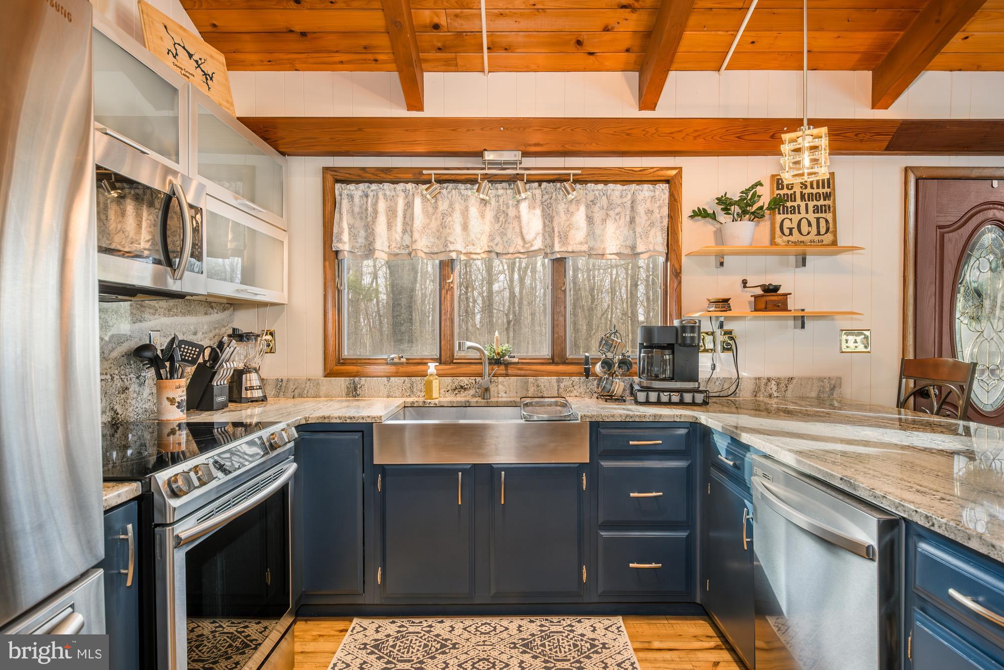 18 Frederick Circle Swanton, MD 21561 - Photo 17 of 63 a kitchen with stainless steel appliances granite countertop a sink stove and cabinets