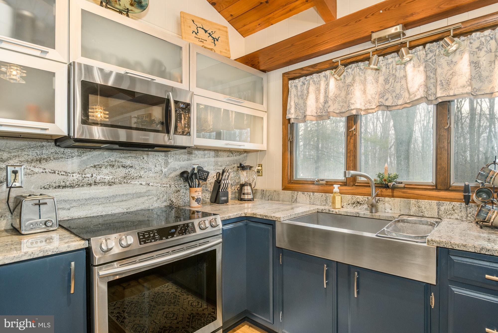 18 Frederick Circle Swanton, MD 21561 - Photo 18 of 63 a kitchen with a sink stove top oven and cabinets