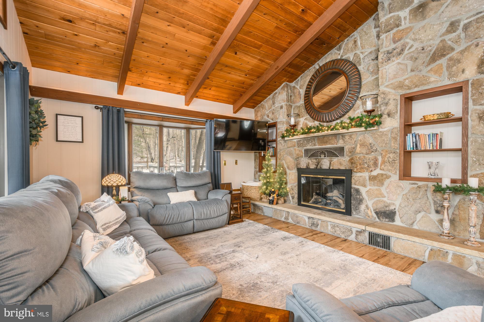 18 Frederick Circle Swanton, MD 21561 - Photo 22 of 63 a living room with furniture a fireplace a flat screen tv and a window