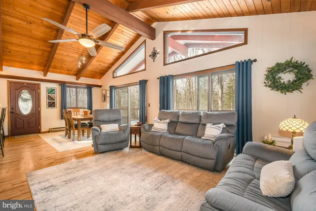 a room with furniture a rug and a window