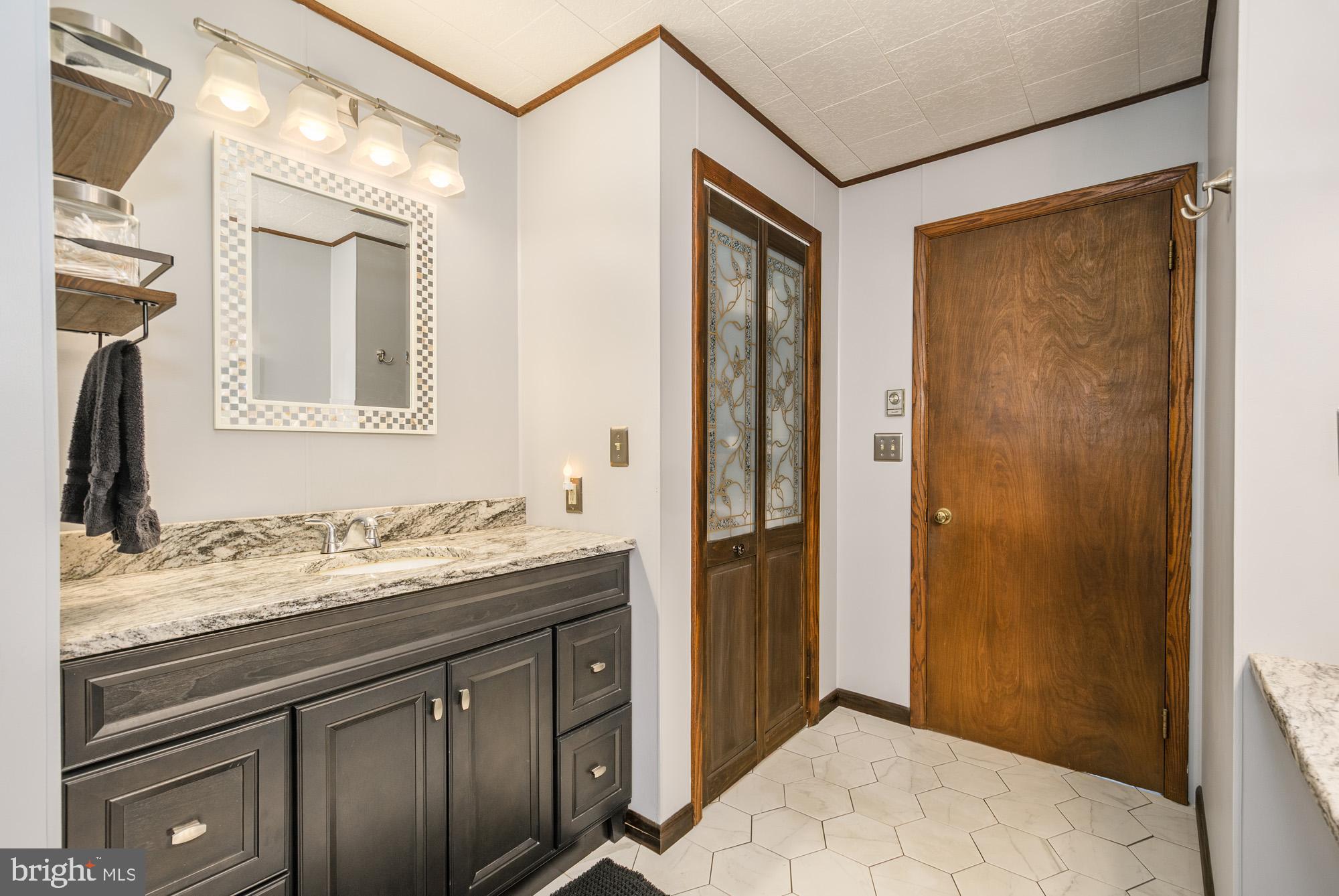 18 Frederick Circle Swanton, MD 21561 - Photo 31 of 64 a bathroom with a sink and a mirror