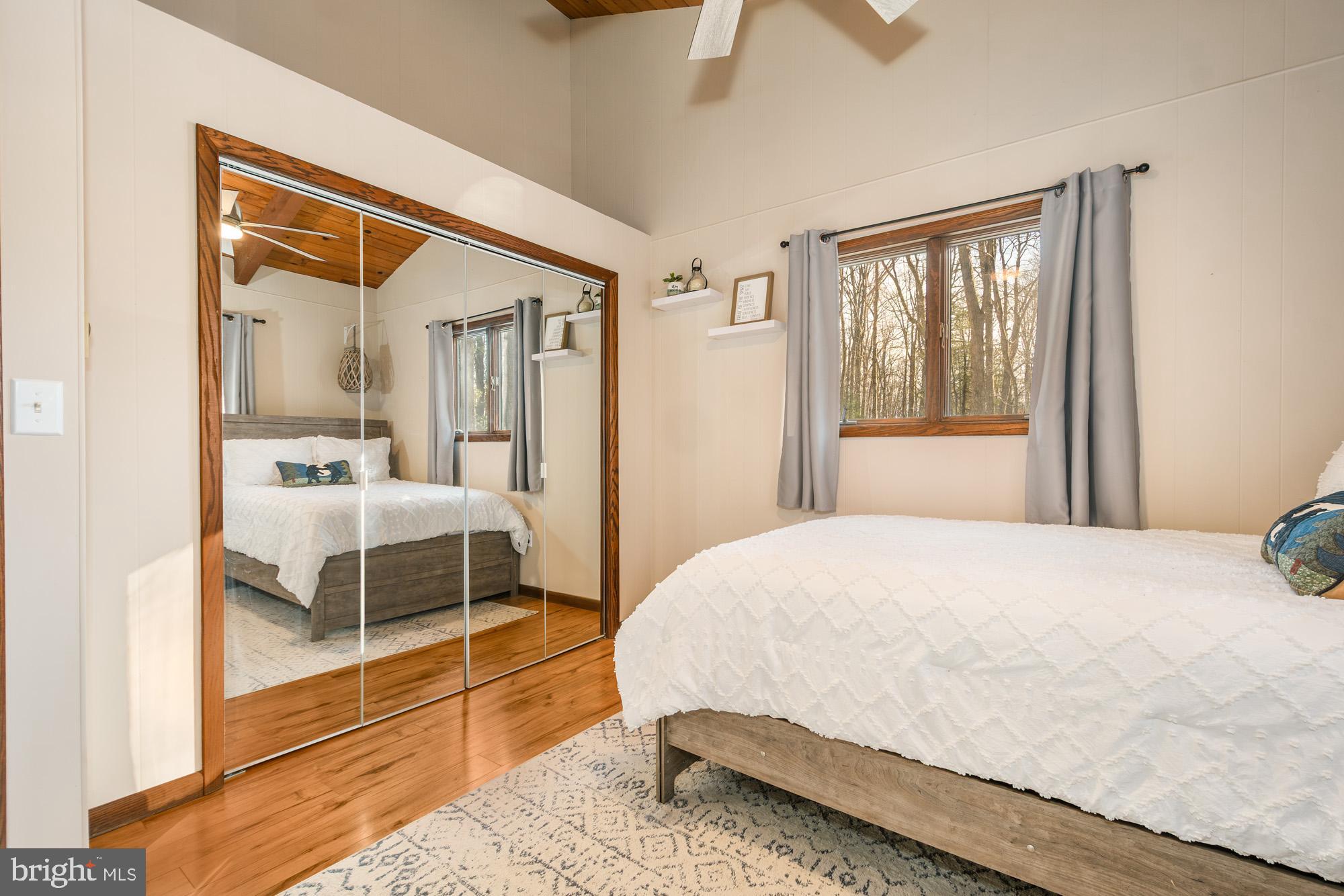 18 Frederick Circle Swanton, MD 21561 - Photo 35 of 63 a bedroom with a bed and a large window with outer view