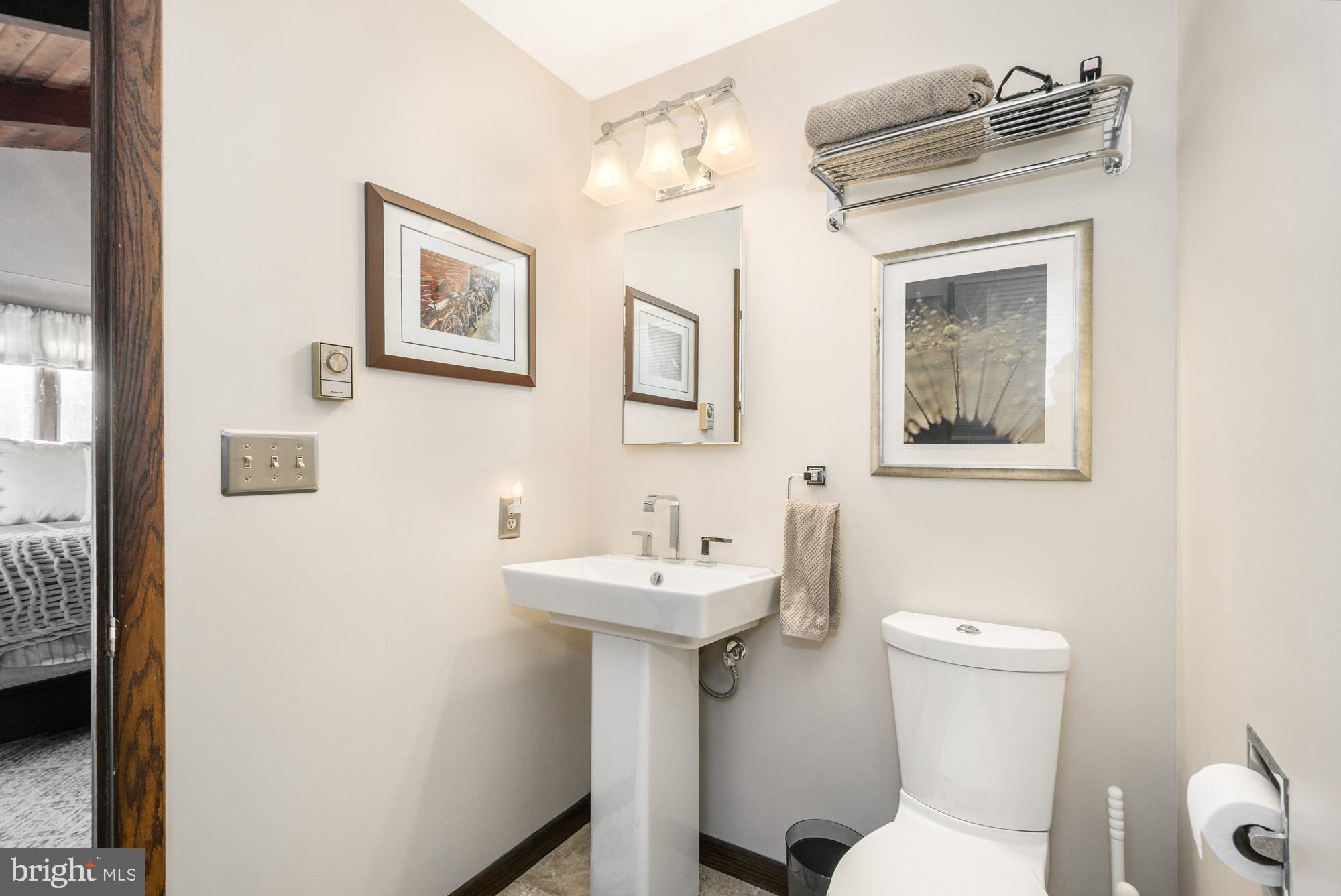 18 Frederick Circle Swanton, MD 21561 - Photo 37 of 63 a bathroom with a sink mirror and a toilet