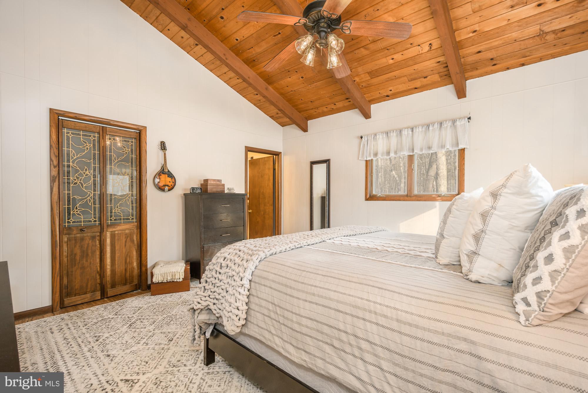 18 Frederick Circle Swanton, MD 21561 - Photo 40 of 63 a bedroom with a large bed and a chandelier