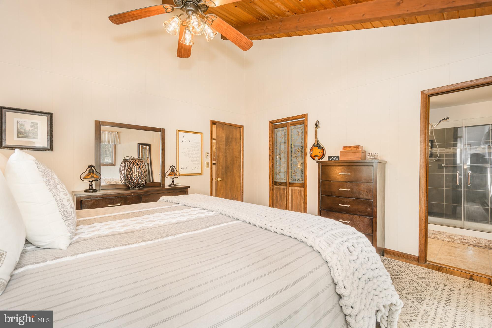 18 Frederick Circle Swanton, MD 21561 - Photo 42 of 63 a bedroom with a large bed and a chandelier