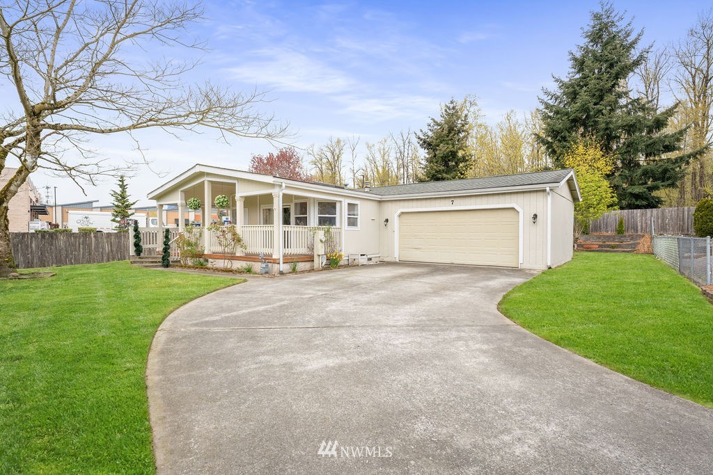 15400 Southeast 155th Place, Unit 7 Renton, WA 98058 - Photo 1 of 26 a front view of a house with a yard and trees