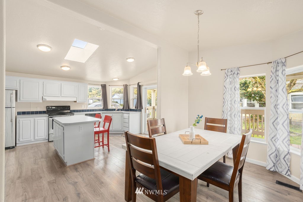 15400 Southeast 155th Place, Unit 7 Renton, WA 98058 - Photo 11 of 26 a large kitchen with a table and chairs