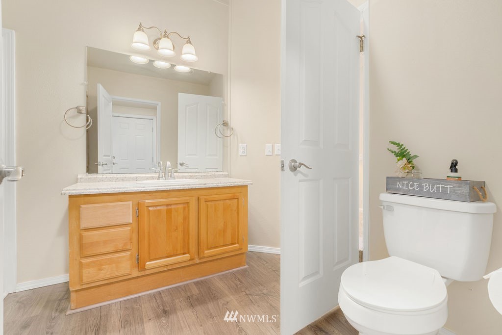 15400 Southeast 155th Place, Unit 7 Renton, WA 98058 - Photo 16 of 26 a bathroom with a granite countertop sink toilet and shower