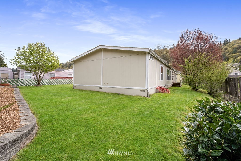 15400 Southeast 155th Place, Unit 7 Renton, WA 98058 - Photo 2 of 26 a view of a house with backyard