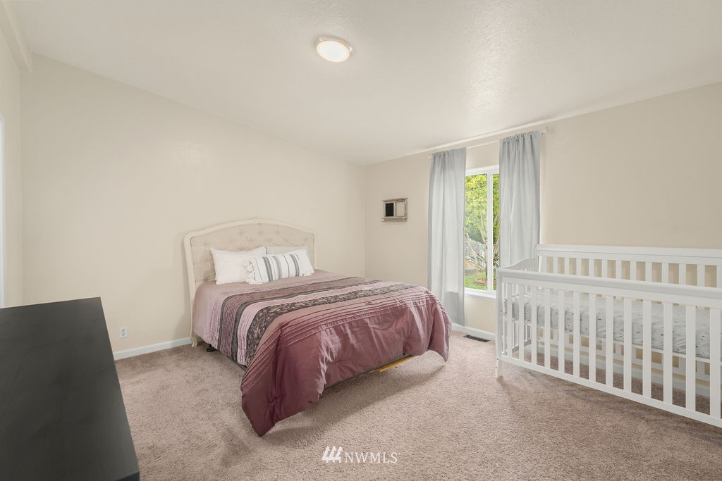 15400 Southeast 155th Place, Unit 7 Renton, WA 98058 - Photo 22 of 26 a bedroom with a bed and a window