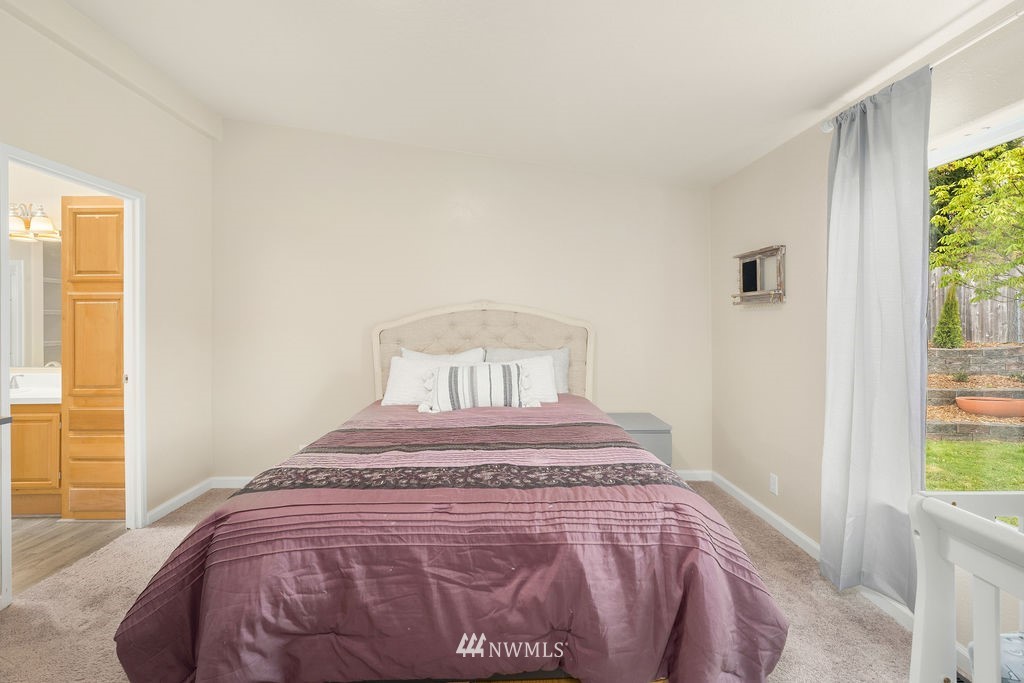 15400 Southeast 155th Place, Unit 7 Renton, WA 98058 - Photo 23 of 26 a bedroom with a bed and a window