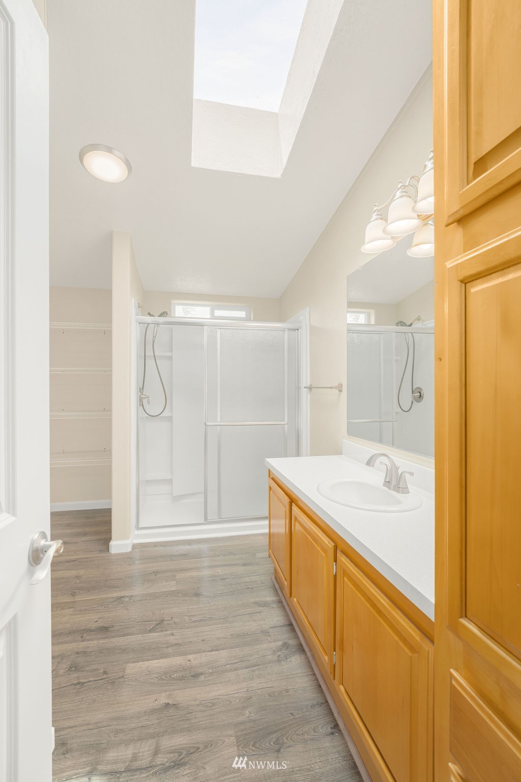 15400 Southeast 155th Place, Unit 7 Renton, WA 98058 - Photo 24 of 26 a bathroom with a granite countertop sink a toilet a mirror and shower