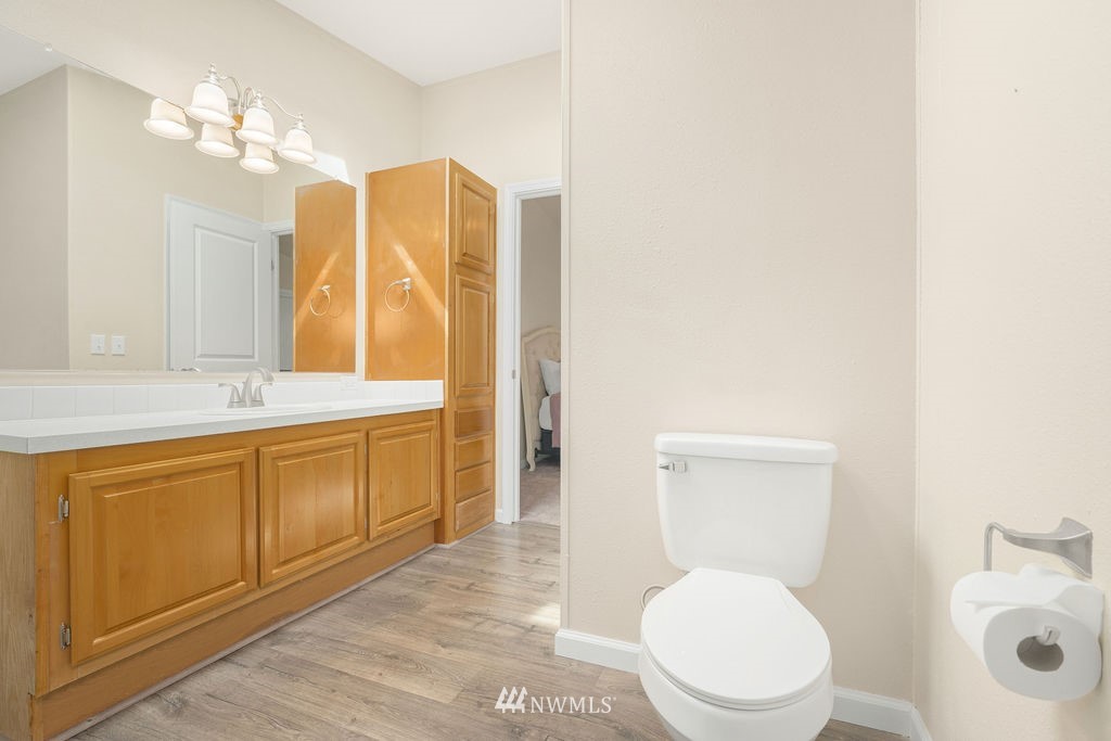 15400 Southeast 155th Place, Unit 7 Renton, WA 98058 - Photo 25 of 26 a spacious bathroom with a toilet sink and mirror