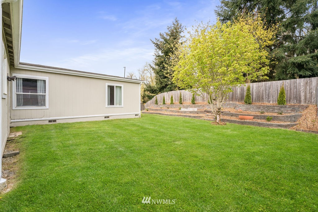 15400 Southeast 155th Place, Unit 7 Renton, WA 98058 - Photo 3 of 26 a backyard of a house with table and chairs