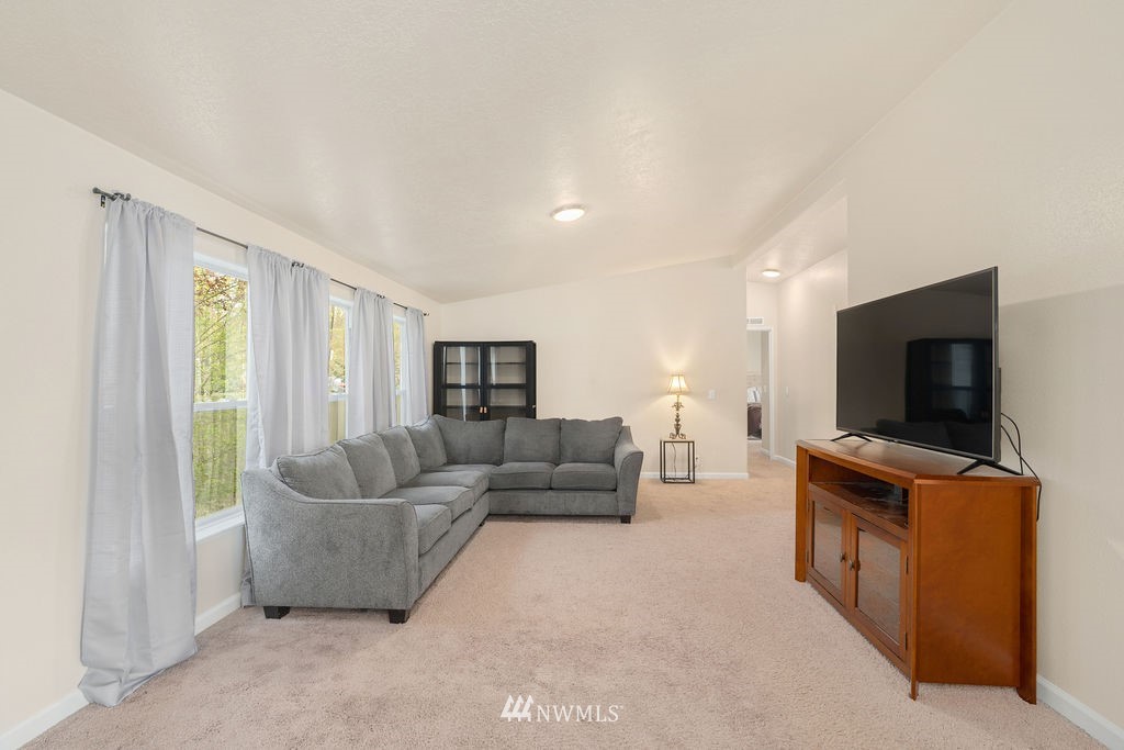 15400 Southeast 155th Place, Unit 7 Renton, WA 98058 - Photo 7 of 26 a living room with furniture and a flat screen tv