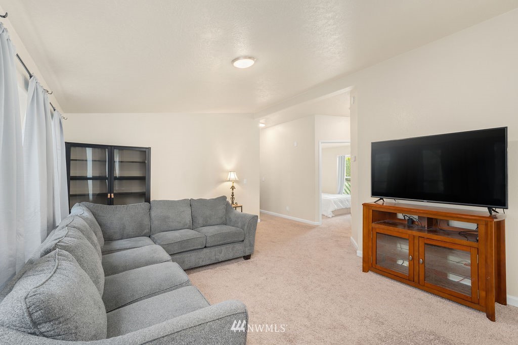 15400 Southeast 155th Place, Unit 7 Renton, WA 98058 - Photo 8 of 26 a living room with furniture and a flat screen tv