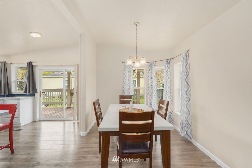 15400 Southeast 155th Place, Unit 7 Renton, WA 98058 - Photo 10 of 26 a view of a dining room with furniture window and wooden floor