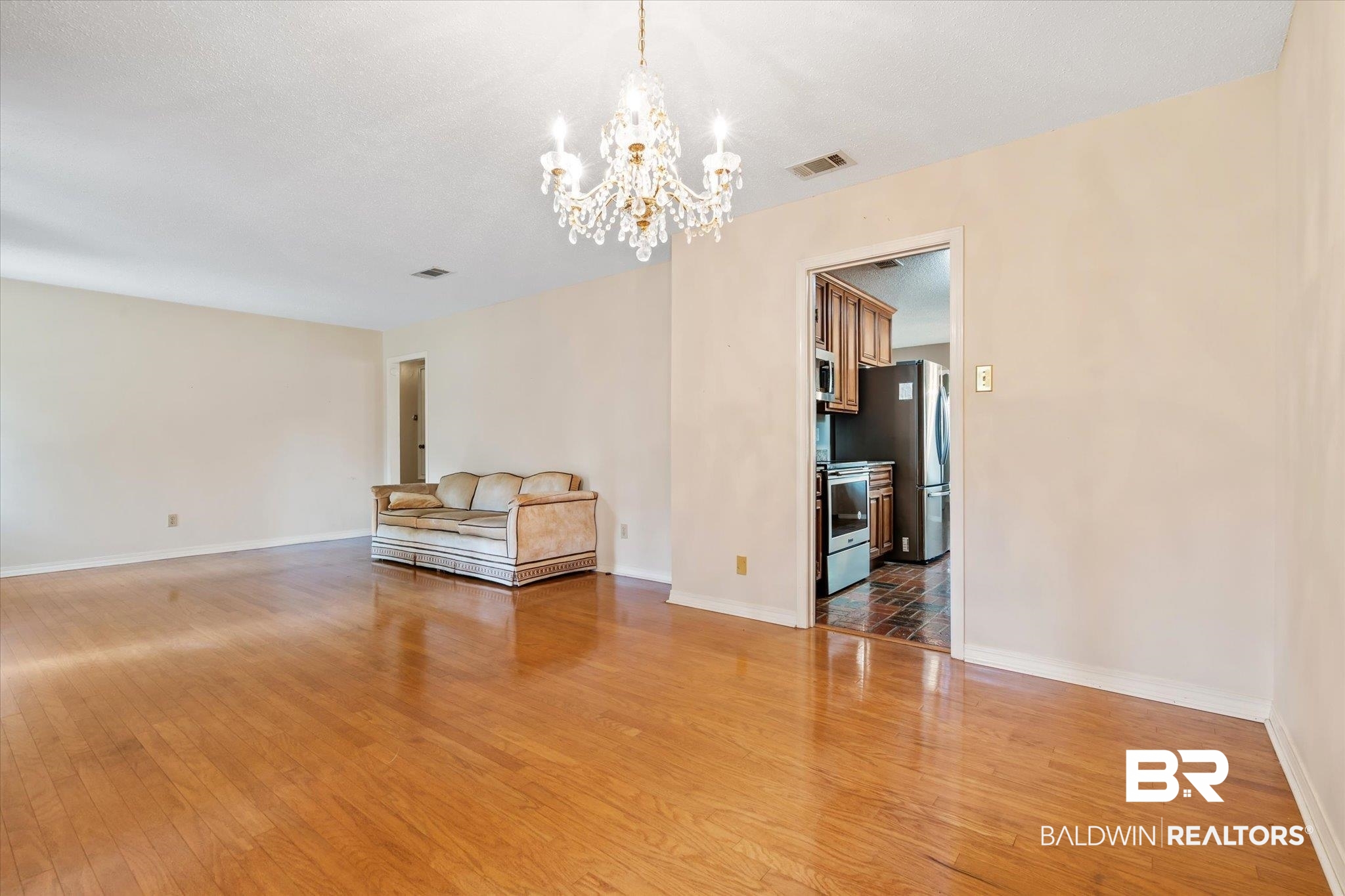 9623 Sunview Drive Semmes, AL 36575 - Photo 7 of 30 Interior space with hardwood / wood-style flooring and an inviting chandelier