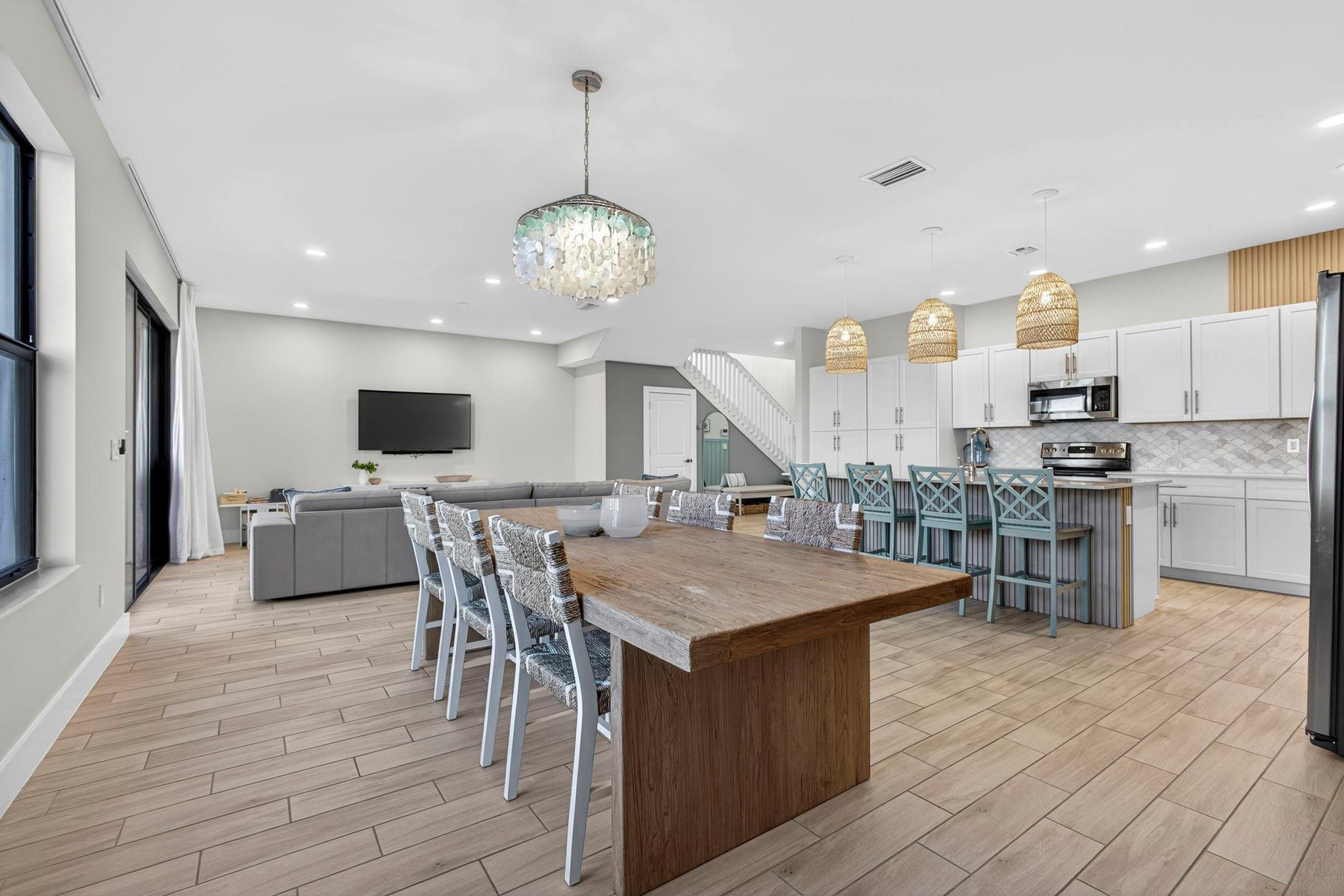 16587 Cove Road The Acreage, FL 33470 - Photo 28 of 69 a kitchen with stainless steel appliances kitchen island granite countertop a table chairs and a refrigerator