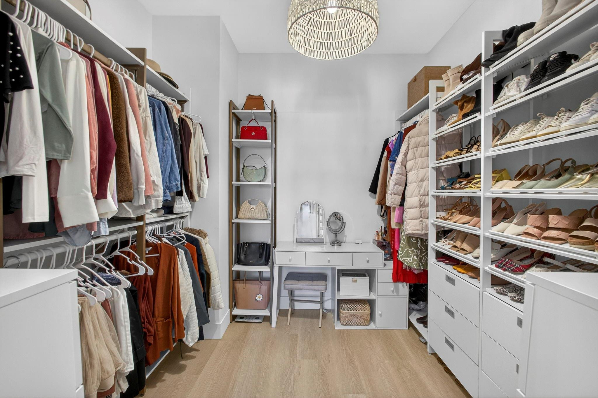 16587 Cove Road The Acreage, FL 33470 - Photo 33 of 69 a view of walk in closet with clothes and shoes