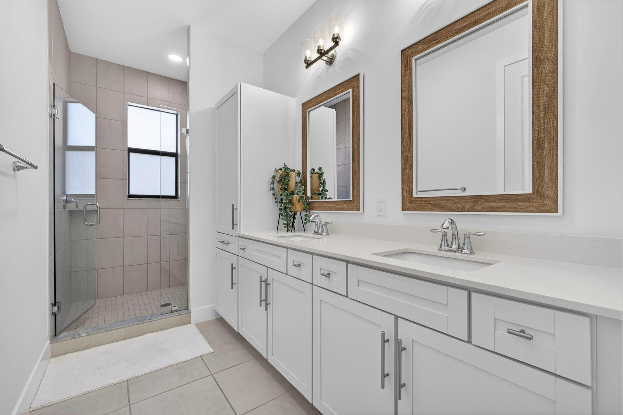16587 Cove Road The Acreage, FL 33470 - Photo 36 of 69 a bathroom with a double vanity sink mirror and