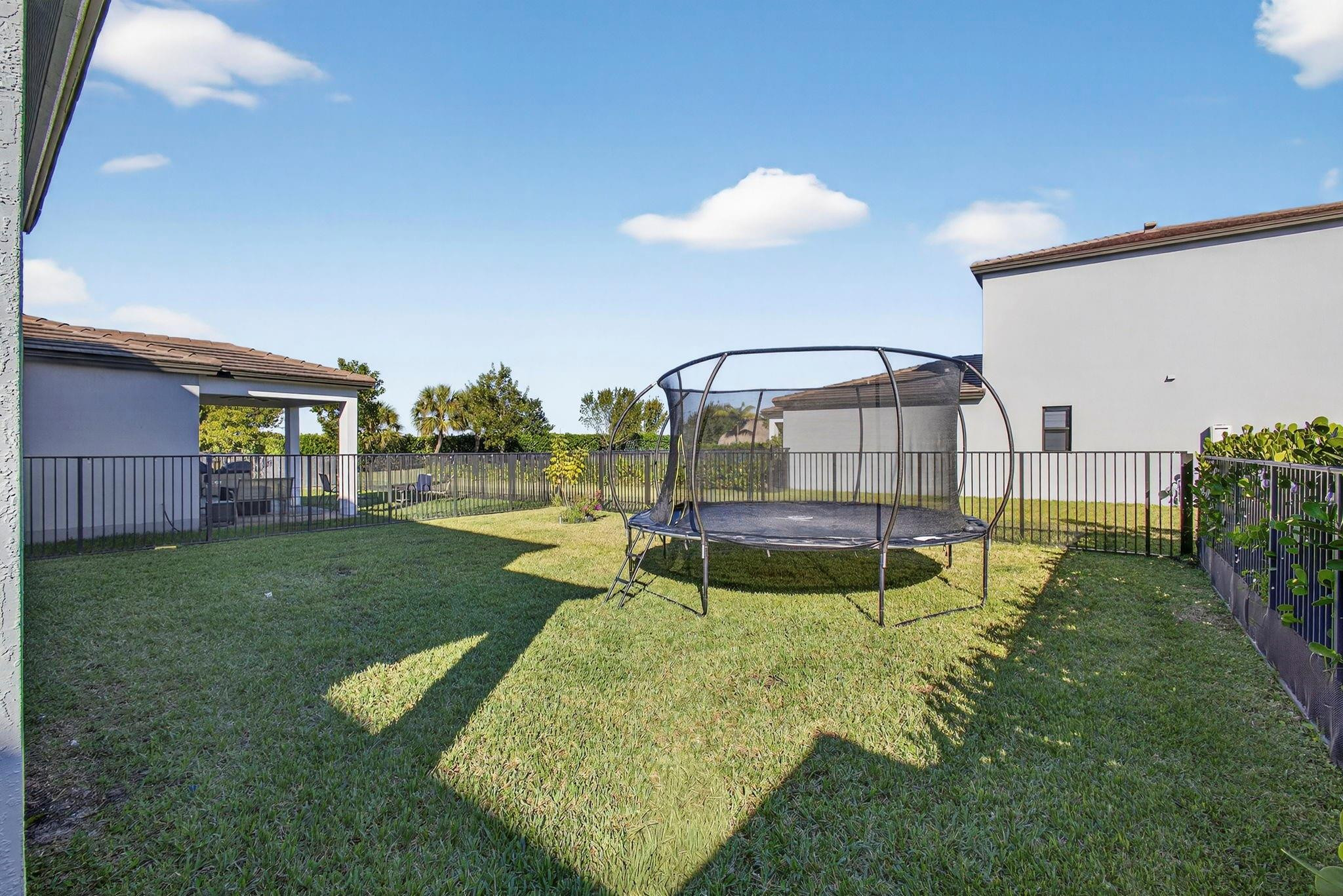 16587 Cove Road The Acreage, FL 33470 - Photo 48 of 69 a view of a house with backyard and a sitting area