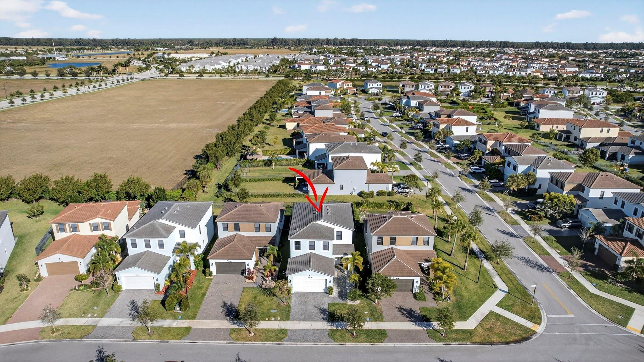16587 Cove Road The Acreage, FL 33470 - Photo 56 of 69 an aerial view of residential building and ocean