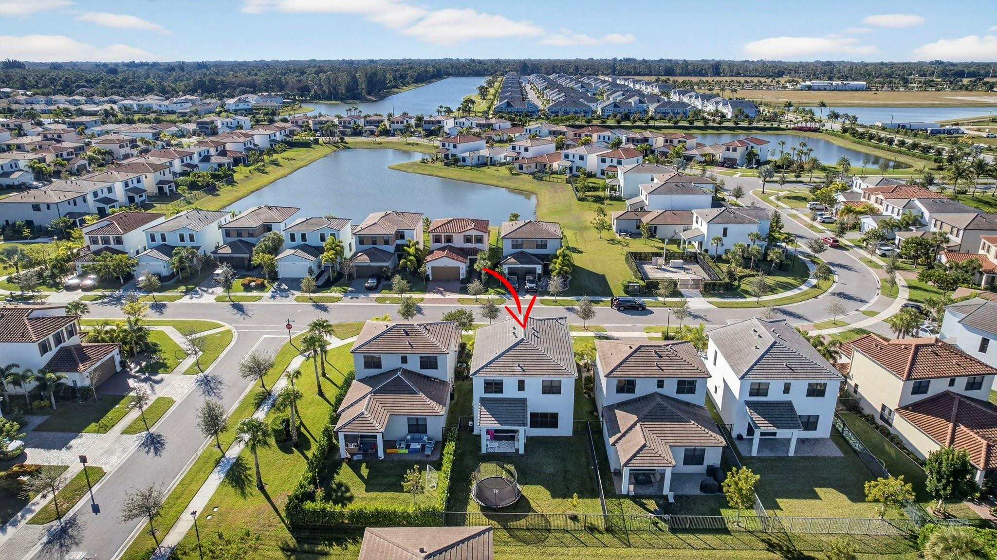 16587 Cove Road The Acreage, FL 33470 - Photo 59 of 69 an aerial view of residential houses with outdoor space and swimming pool